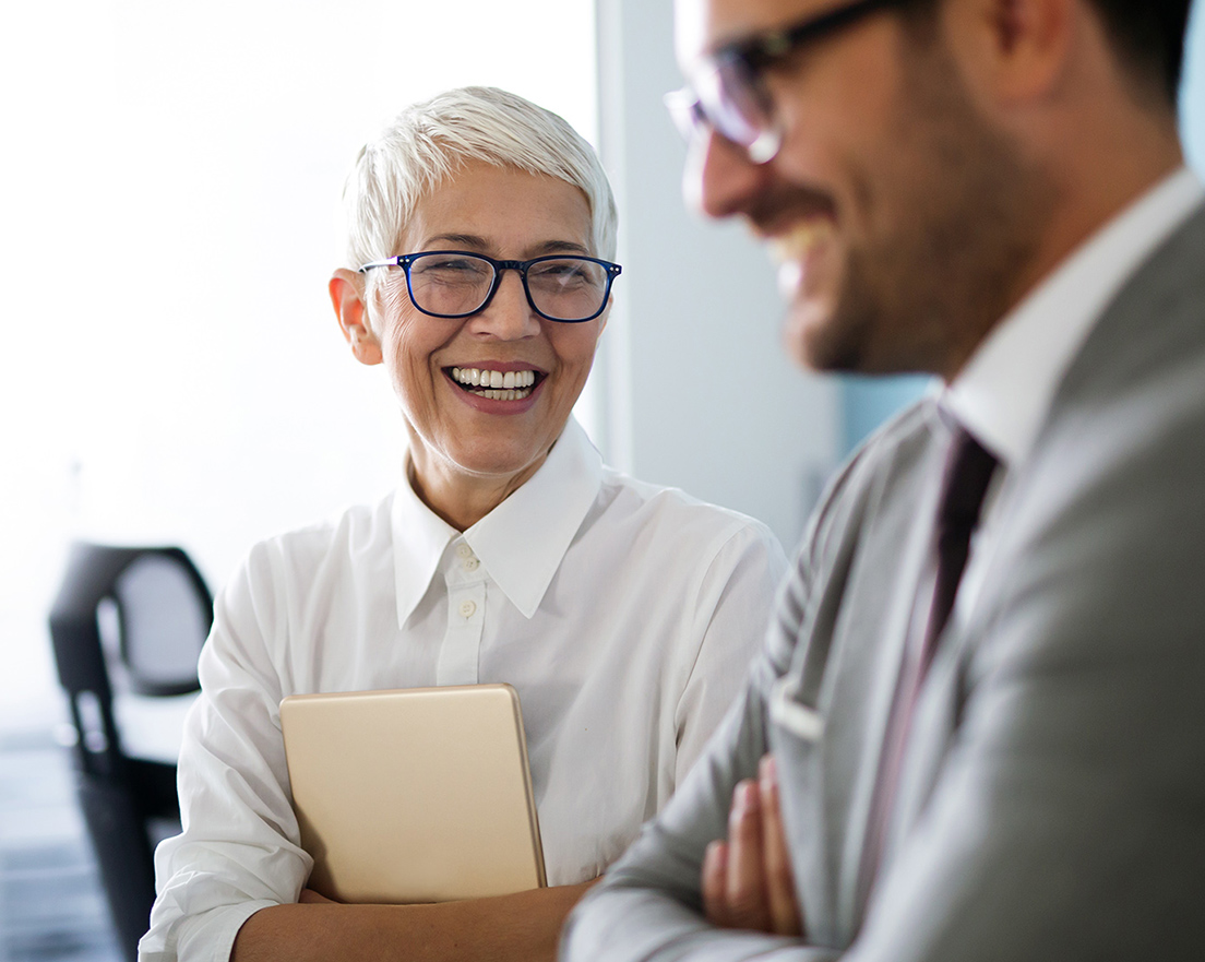 Due diligence professionals conversing and smiling